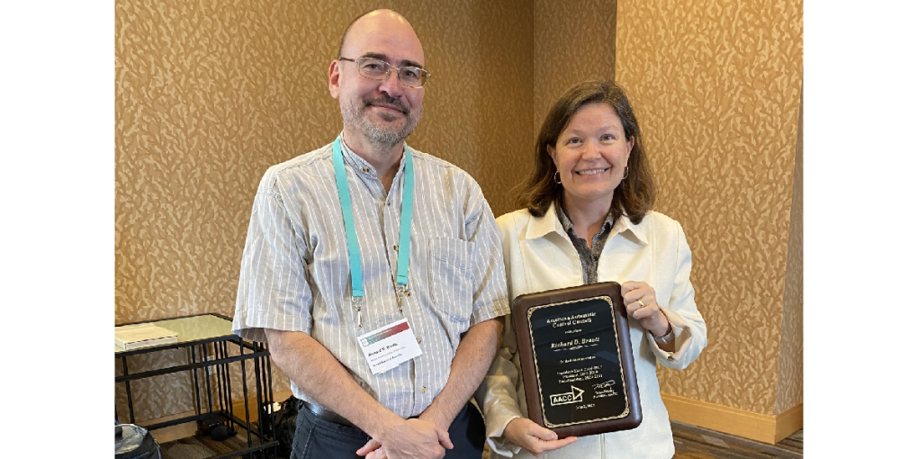 Richard Braatz receiving recognition plaque